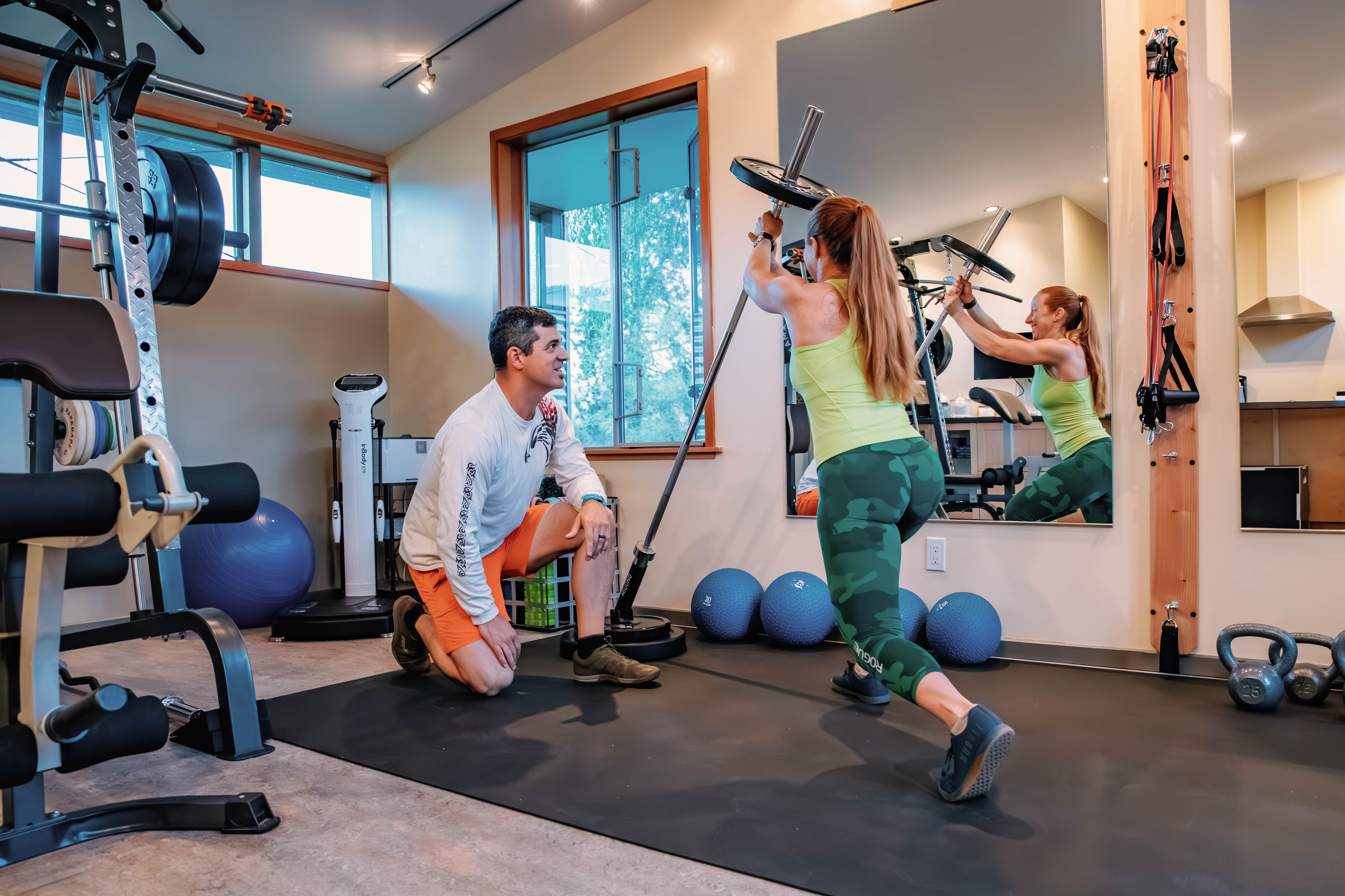 A man assisting a woman with personal training